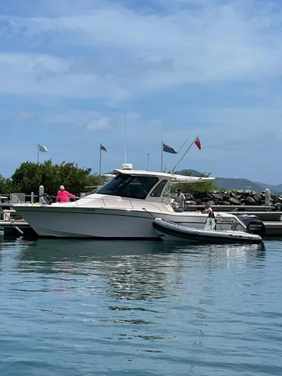  Yacht Photos Pics 2013 Grady-White Express 330 boat docked with inflatable dinghy nearby.