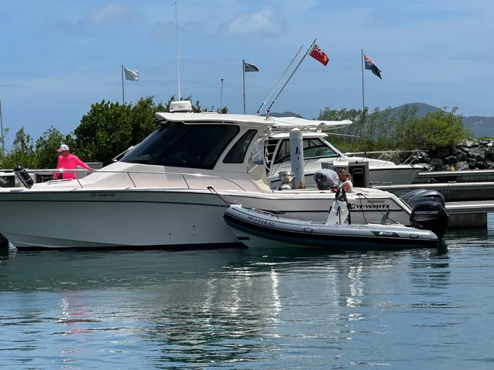  Yacht Photos Pics 2013 Grady-White Express 330 boat docked with inflatable dinghy nearby.