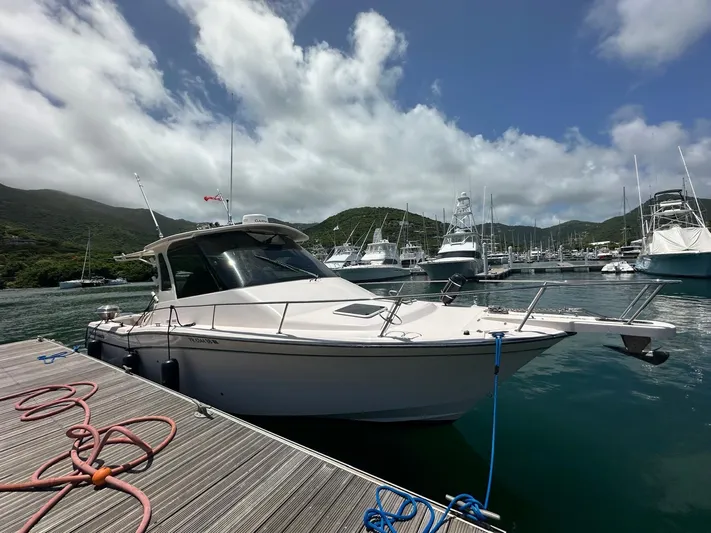  Yacht Photos Pics 2013 Grady-White Express 330 boat docked in a marina with scenic mountain backdrop.
