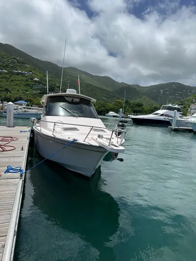  Yacht Photos Pics 2013 Grady-White Express 330 boat docked in scenic marina with lush hills.