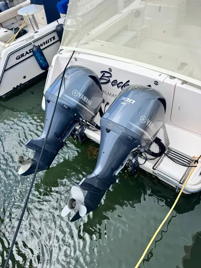  Yacht Photos Pics 2013 Grady-White Express 330 with twin Yamaha outboard motors docked in water.