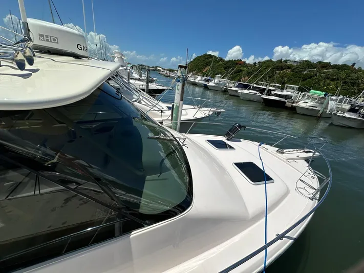  Yacht Photos Pics 2013 Grady-White Express 330 docked in a marina under clear blue skies.