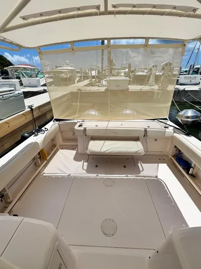  Yacht Photos Pics 2013 Grady-White Express 330 boat interior with seating and canopy in marina.