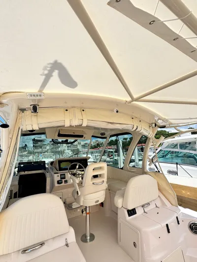  Yacht Photos Pics Interior of 2013 Grady-White Express 330 boat with white seating and helm.