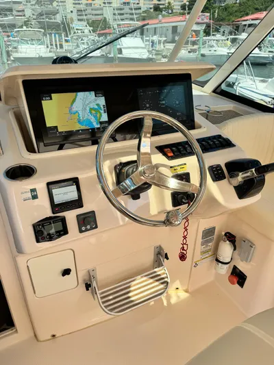  Yacht Photos Pics 2013 Grady-White Express 330 helm with navigation system and steering wheel.