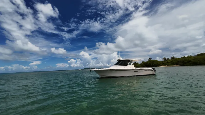  Yacht Photos Pics 2013 Grady-White Express 330 boat on calm ocean under blue sky.