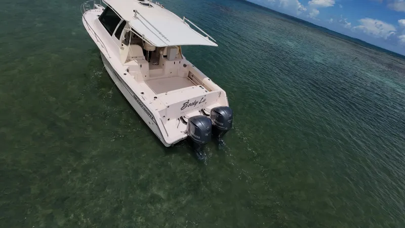 Yacht Photos Pics 2013 Grady-White Express 330 boat on clear water, aerial view.