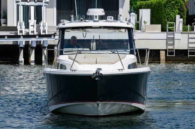 325 Boston Whaler W/ Seakeeper Stabilizer & Ride Yacht Photos Pics 2020 Boston Whaler 325 Conquest boat docked on calm water, front view.