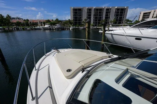 325 Boston Whaler W/ Seakeeper Stabilizer & Ride Yacht Photos Pics 2020 Boston Whaler 325 Conquest docked in a marina with waterfront buildings.