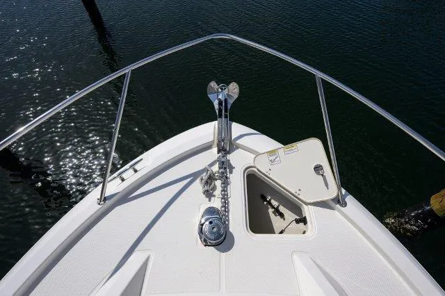 325 Boston Whaler W/ Seakeeper Stabilizer & Ride Yacht Photos Pics Bow of 2020 Boston Whaler 325 Conquest with anchor and hatch, on water.