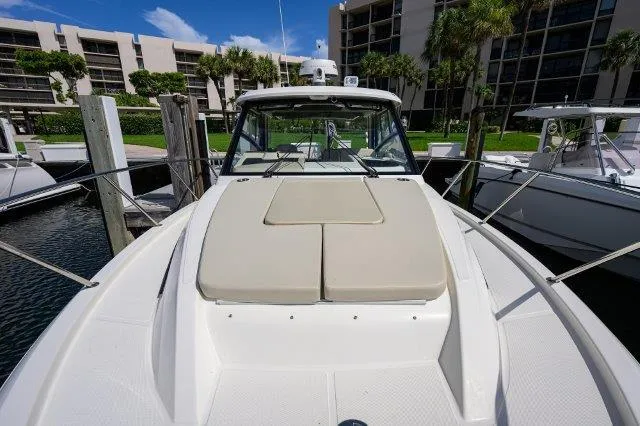 325 Boston Whaler W/ Seakeeper Stabilizer & Ride Yacht Photos Pics 2020 Boston Whaler 325 Conquest boat docked, featuring spacious deck and modern design.