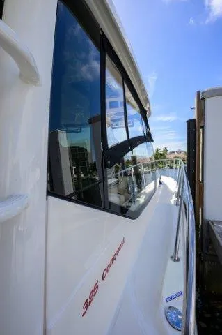 325 Boston Whaler W/ Seakeeper Stabilizer & Ride Yacht Photos Pics 2020 Boston Whaler 325 Conquest boat side view with clear blue sky.