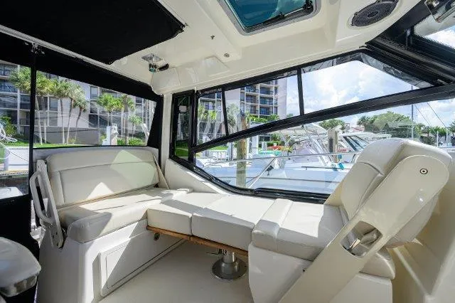 325 Boston Whaler W/ Seakeeper Stabilizer & Ride Yacht Photos Pics Interior of 2020 Boston Whaler 325 Conquest boat with luxurious seating and large windows.