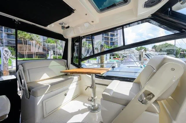 325 Boston Whaler W/ Seakeeper Stabilizer & Ride Yacht Photos Pics Interior of 2020 Boston Whaler 325 Conquest boat with seating and table.