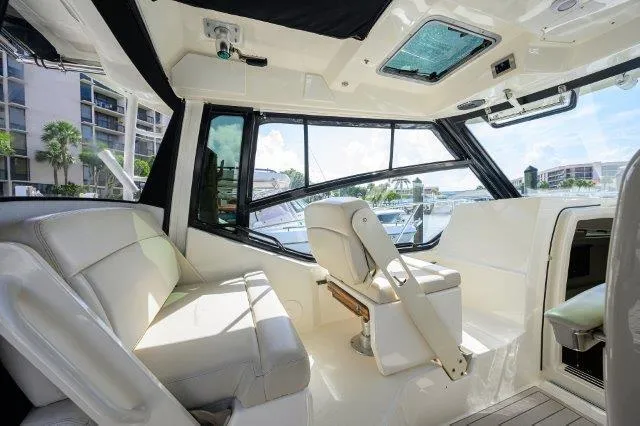 325 Boston Whaler W/ Seakeeper Stabilizer & Ride Yacht Photos Pics 2020 Boston Whaler 325 Conquest interior with plush seating and panoramic windows.