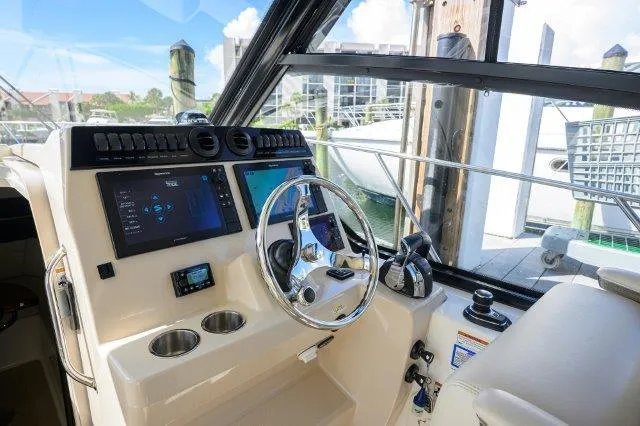 325 Boston Whaler W/ Seakeeper Stabilizer & Ride Yacht Photos Pics 2020 Boston Whaler 325 Conquest helm with modern controls and navigation screens.