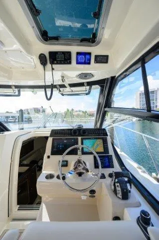 325 Boston Whaler W/ Seakeeper Stabilizer & Ride Yacht Photos Pics 2020 Boston Whaler 325 Conquest helm with advanced navigation systems and panoramic windows.