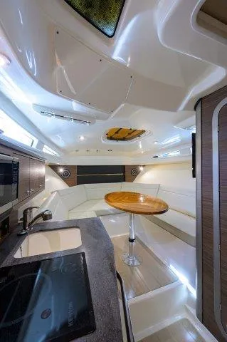 325 Boston Whaler W/ Seakeeper Stabilizer & Ride Yacht Photos Pics Interior of 2020 Boston Whaler 325 Conquest, featuring modern kitchen and seating area.