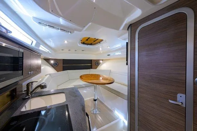 325 Boston Whaler W/ Seakeeper Stabilizer & Ride Yacht Photos Pics 2020 Boston Whaler 325 Conquest cabin interior with modern kitchen and seating area.