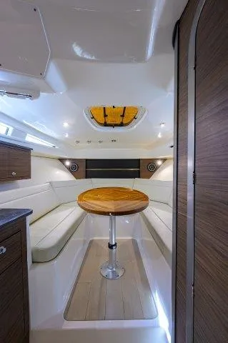 325 Boston Whaler W/ Seakeeper Stabilizer & Ride Yacht Photos Pics Interior of 2020 Boston Whaler 325 Conquest with elegant seating and wooden table.