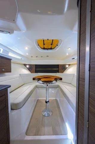325 Boston Whaler W/ Seakeeper Stabilizer & Ride Yacht Photos Pics 2020 Boston Whaler 325 Conquest cabin interior with seating and table.