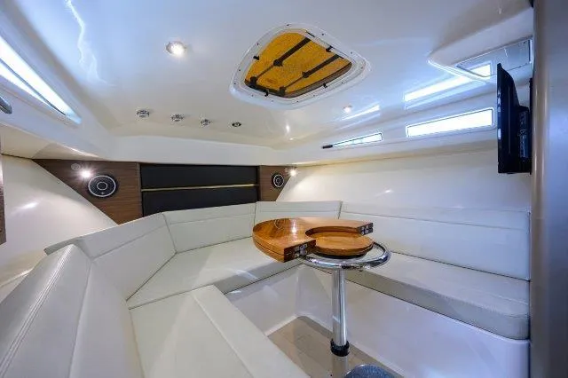 325 Boston Whaler W/ Seakeeper Stabilizer & Ride Yacht Photos Pics 2020 Boston Whaler 325 Conquest cabin interior with seating and table.