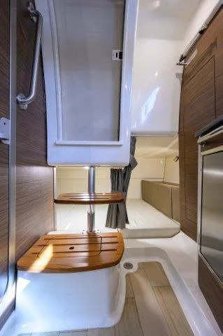 325 Boston Whaler W/ Seakeeper Stabilizer & Ride Yacht Photos Pics Interior of 2020 Boston Whaler 325 Conquest, featuring wooden steps and modern design.