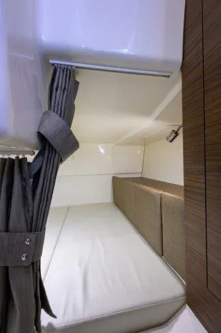 325 Boston Whaler W/ Seakeeper Stabilizer & Ride Yacht Photos Pics 2020 Boston Whaler 325 Conquest cabin interior with bed and curtain.