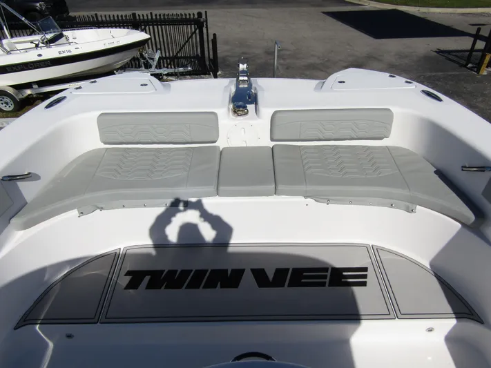  Yacht Photos Pics 2023 Twin Vee 340 GFX CC boat interior with cushioned seating and logo.