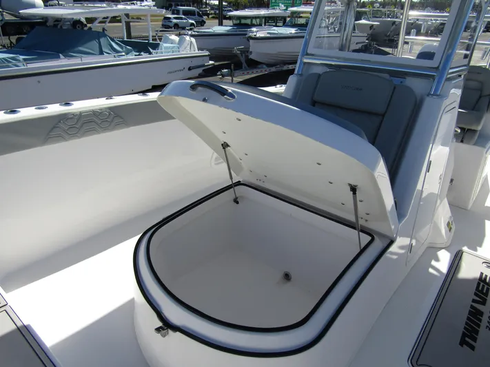  Yacht Photos Pics 2023 Twin Vee 340 GFX CC boat with open storage compartment, docked at marina.
