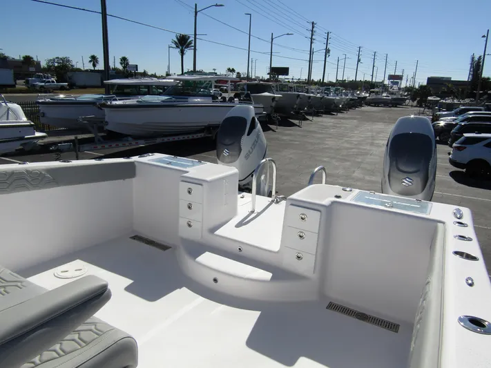  Yacht Photos Pics 2023 Twin Vee 340 GFX CC boat interior with dual engines in a marina setting.