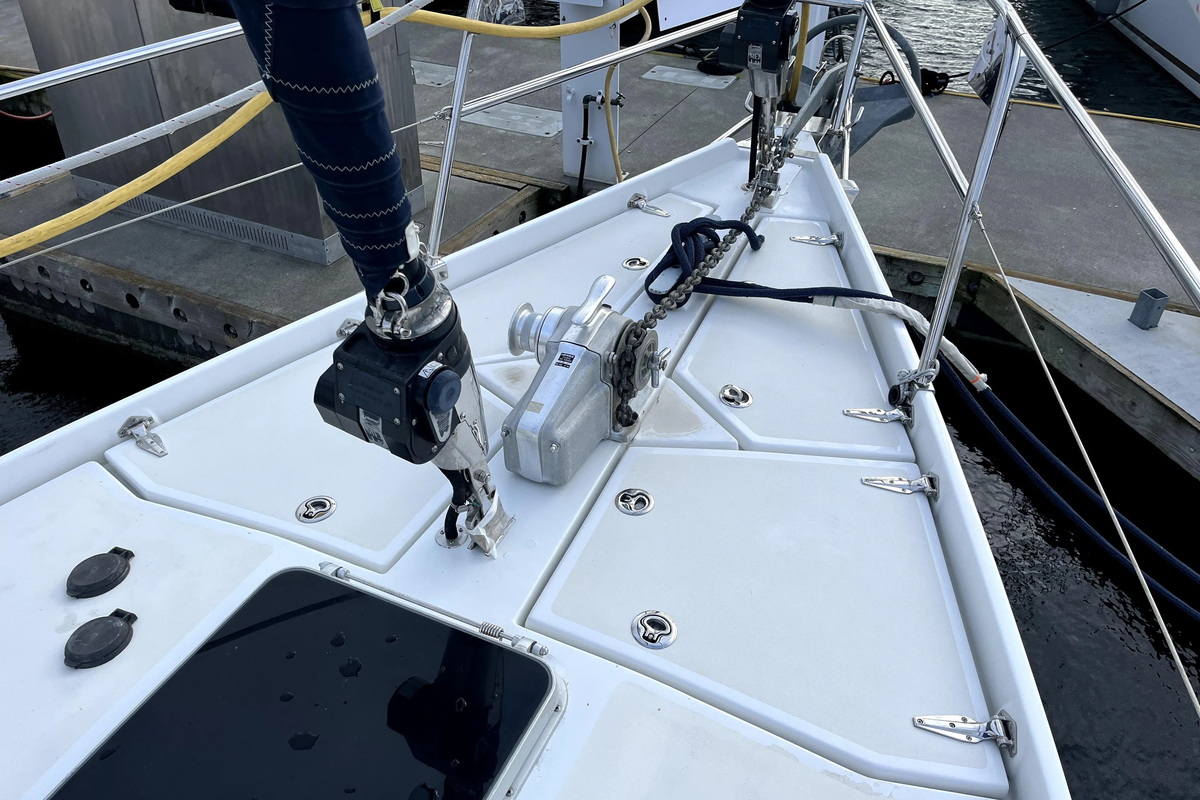 Deck of 1979 Amel Mango sailboat with winch and rigging at dock.