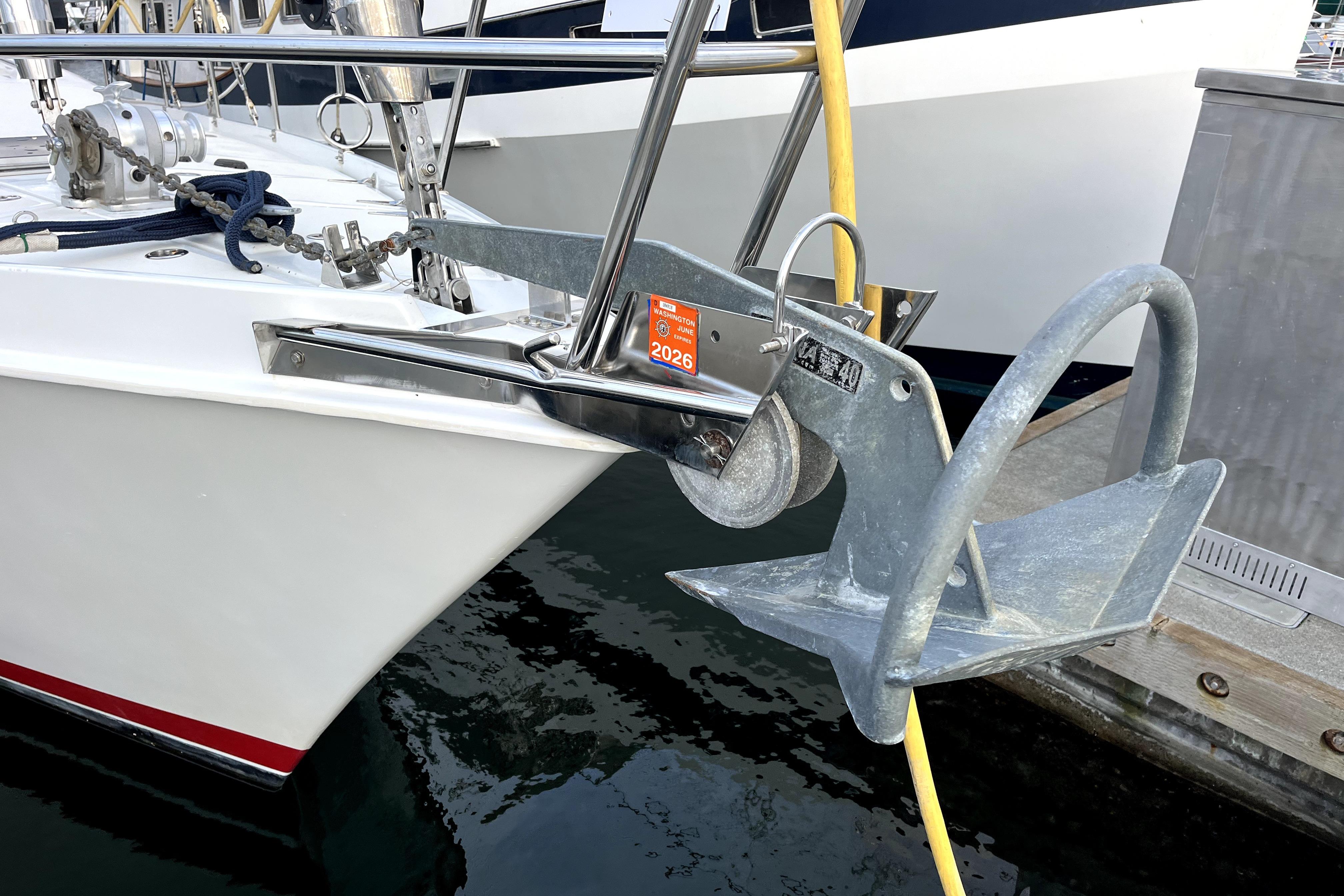 1979 Amel Mango sailboat with anchor and mooring equipment at dock.