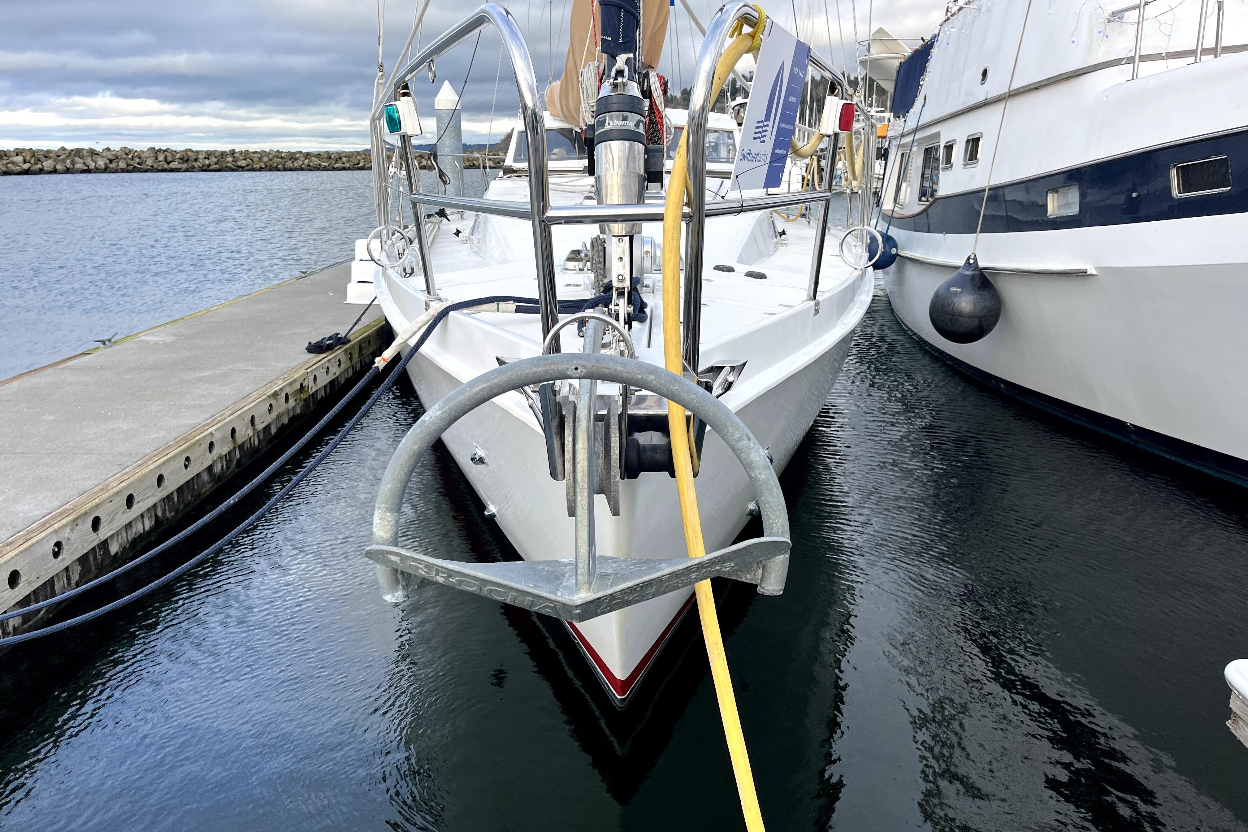 1979 Amel Mango yacht docked at marina, front view with anchor and ropes.