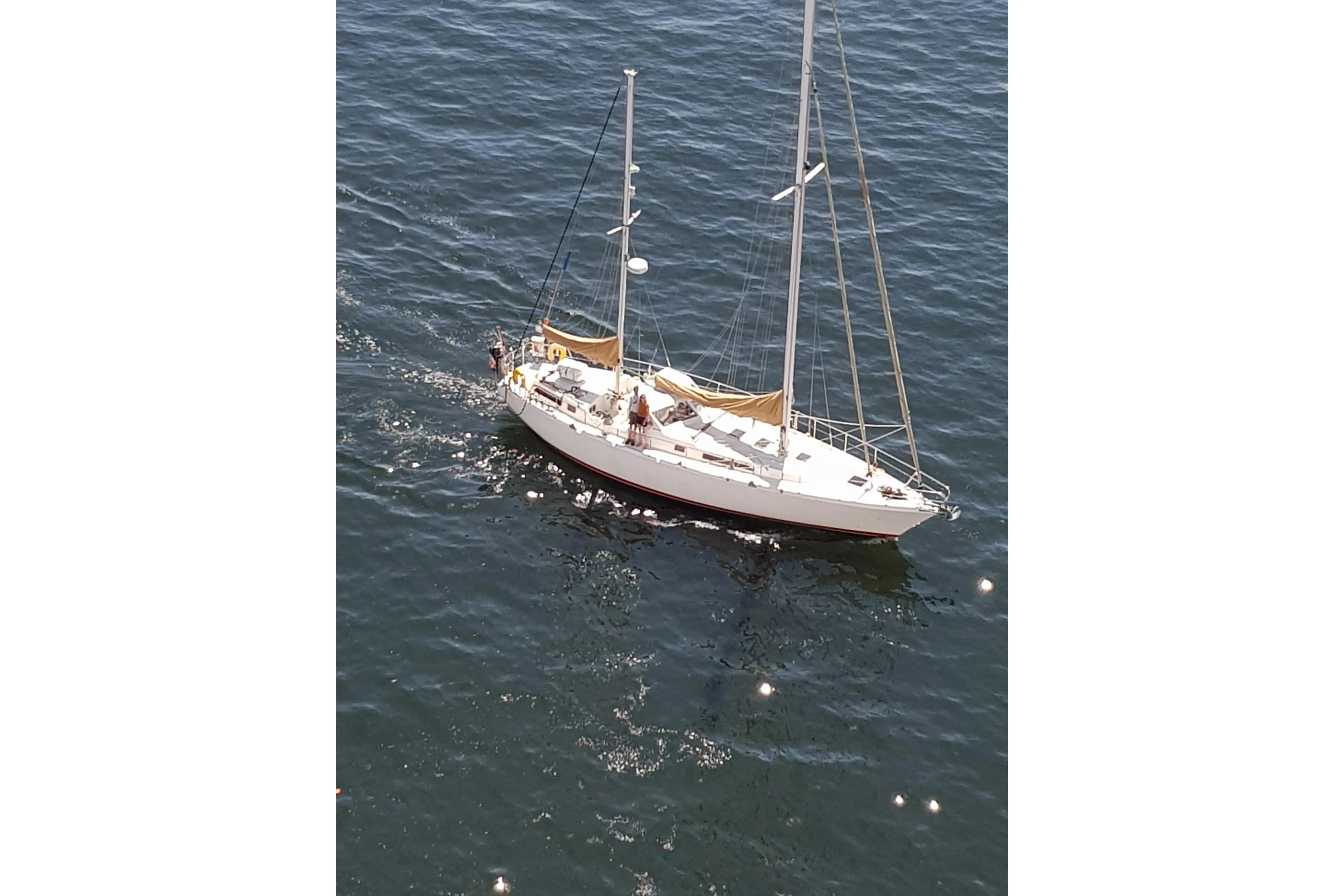 1979 Amel Mango sailboat cruising on open water, viewed from above.