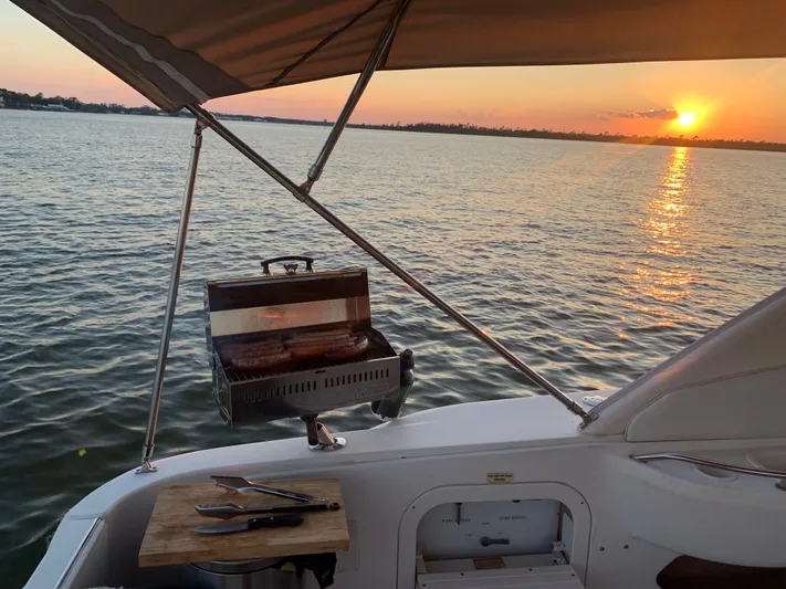  Yacht Photos Pics Sea Ray 450 Sundancer 1998 yacht with sunset view and onboard grill.