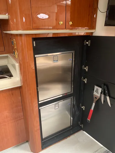  Yacht Photos Pics 1998 Sea Ray 450 Sundancer kitchen with stainless steel appliances and wooden cabinetry.