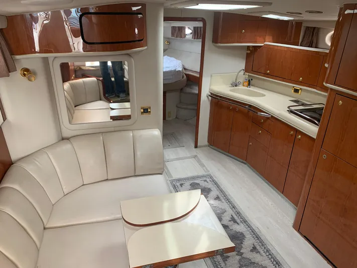 Yacht Photos Pics 1998 Sea Ray 450 Sundancer interior with leather seating, wooden cabinetry, and modern kitchen amenities.