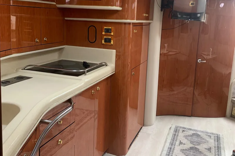  Yacht Photos Pics 1998 Sea Ray 450 Sundancer interior kitchen with wood cabinetry and modern appliances.