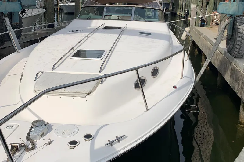  Yacht Photos Pics 1998 Sea Ray 450 Sundancer docked, showcasing sleek design and spacious deck.