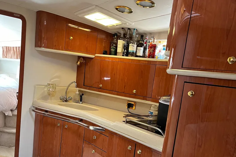  Yacht Photos Pics Luxurious 1998 Sea Ray 450 Sundancer yacht kitchen with wood cabinets and modern amenities.
