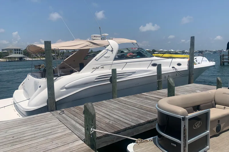  Yacht Photos Pics 1998 Sea Ray 450 Sundancer yacht docked at a marina on a sunny day.