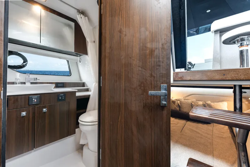  Yacht Photos Pics 2023 Cruisers Yachts 42 GLS OB interior with modern bathroom and wooden cabinetry.