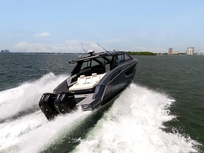  Yacht Photos Pics 2023 Cruisers Yachts 42 GLS OB speeding on water, showcasing sleek design and powerful engines.