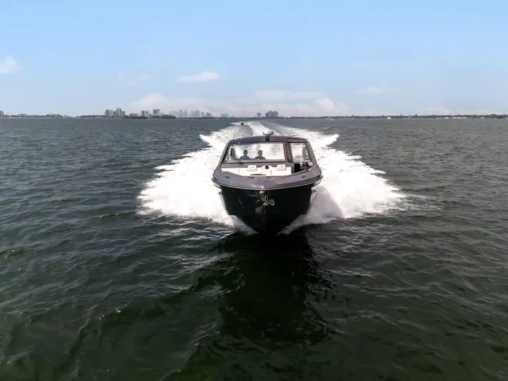  Yacht Photos Pics 2023 Cruisers Yachts 42 GLS OB speeding on open water under clear skies.