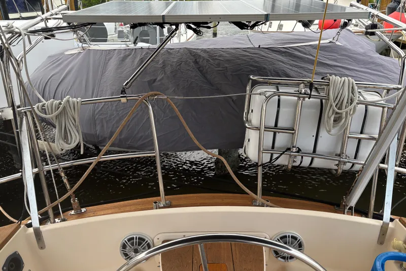 Starlight Yacht Photos Pics Sailboat cockpit view with solar panels and covered equipment, Island Packet 37, 1995 model.