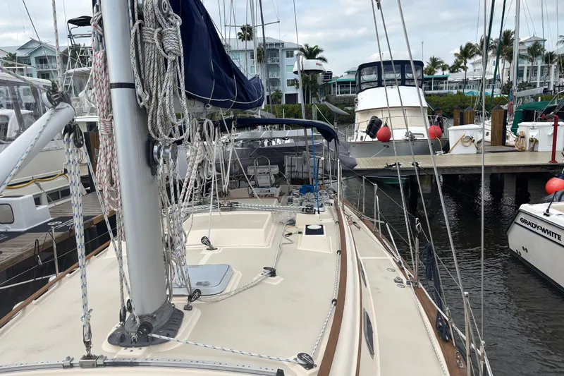 Starlight Yacht Photos Pics 1995 Island Packet 37 sailboat docked at marina with other boats.