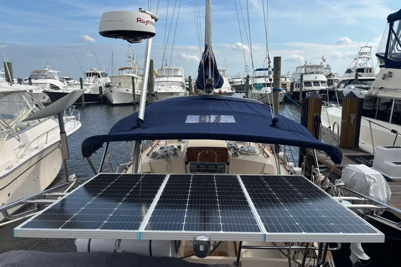 Starlight Yacht Photos Pics 1995 Island Packet 37 sailboat with solar panels docked at a marina.