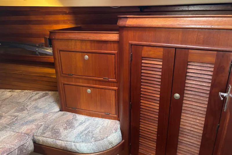 Starlight Yacht Photos Pics Interior of 1995 Island Packet 37 sailboat with wooden cabinets and cushioned seating.