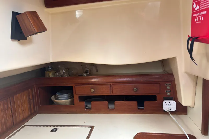 Starlight Yacht Photos Pics Interior of 1995 Island Packet 37 sailboat with wooden cabinetry and storage.